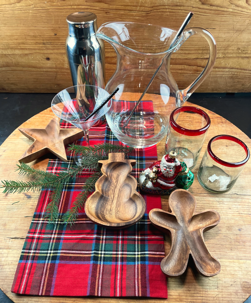 Sustainable holiday table setting with recycled glassware from Mexico and holiday shaped wood serving dishes