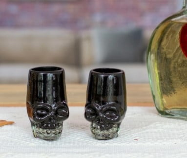 Handblown recycled glass tequila glasses, 'Black Mexican Skull' (pair)